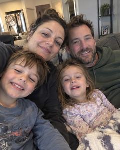 Example phone photo: a selfie of a family of four on the sofa at home