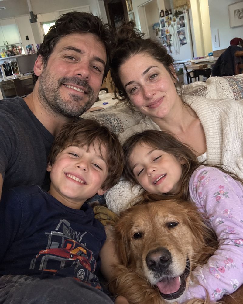 Example phone photo: a selfie of a family of four and their golden retriever at home