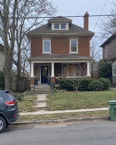 Example phone photo: a brick house with a porch on an overcast day