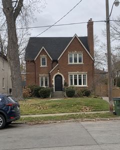 Example phone photo: a brick house with steep gables on an overcast autumn day