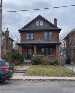 Example phone photo: a brick house with a porch on an overcast day