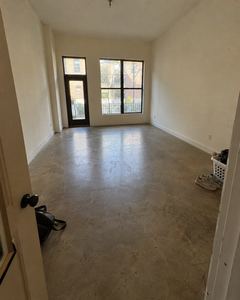Example phone photo: an empty room with a concrete floor and two tall windows