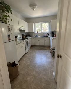 Example phone photo: a dated white kitchen with a cluttered fridge