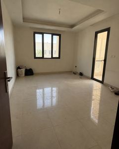 Example phone photo: an empty room with a tiled floor and bare windows