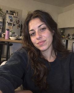 Example phone photo: a selfie of a woman in a dark sweater in her kitchen