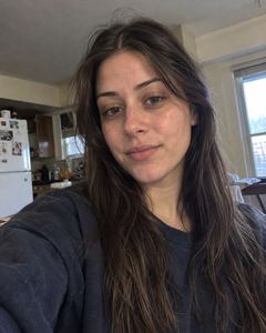 Example phone photo: a selfie of a woman with long dark hair at home