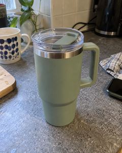 Example phone photo: a sage-green tumbler on a cluttered kitchen counter